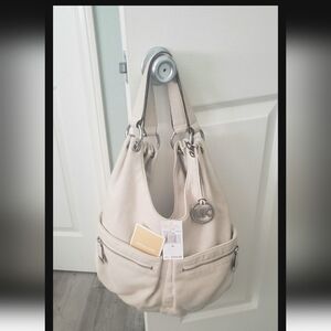 Michael Korda -cream shoulder bag. Excellent Condition.Minor Stain under pocket.